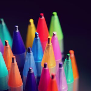 multi colored pen lot on black background